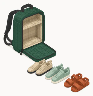 An open green backpack with its front panel folded down, with cream walking shoes, sage sneakers and terracotta strap sandals lined up in front of it.